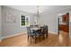 Elegant dining room with a chandelier, hardwood floors, and large windows providing ample light at 1033 Estes St, Lakewood, CO 80215