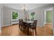Bright dining room featuring hardwood floors, natural light, and a stylish chandelier at 1033 Estes St, Lakewood, CO 80215