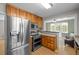 Modern kitchen with stainless steel appliances, built in microwave and adjacent seating area at 1033 Estes St, Lakewood, CO 80215