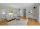 Well-lit living room boasts hardwood floors, neutral walls, and comfortable seating area at 1033 Estes St, Lakewood, CO 80215