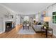 Cozy living room with a fireplace, hardwood floors, and stylish furnishings creating a welcoming atmosphere at 1033 Estes St, Lakewood, CO 80215