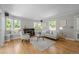 Bright living room features a fireplace, hardwood floors, and bay windows with built in seating at 1033 Estes St, Lakewood, CO 80215