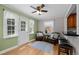 Cozy living room features hardwood floors, ceiling fan, and access to the backyard at 1033 Estes St, Lakewood, CO 80215
