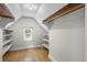 Spacious walk-in closet with built-in shelving and a bright window at 1033 Estes St, Lakewood, CO 80215