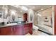 Beautiful bathroom with granite countertop, unique rock wall decor, and glass-enclosed shower at 6430 Silver Mesa Dr # D, Highlands Ranch, CO 80130