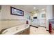 Bright, spacious bathroom featuring a luxurious jacuzzi tub, walk-in shower, and double sinks at 6430 Silver Mesa Dr # D, Highlands Ranch, CO 80130