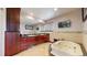 Relaxing bathroom featuring a jacuzzi tub, granite counters and cherry wood cabinets at 6430 Silver Mesa Dr # D, Highlands Ranch, CO 80130