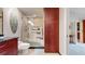 Bathroom with granite countertop, tiled glass enclosed shower and extra cabinet storage at 6430 Silver Mesa Dr # D, Highlands Ranch, CO 80130