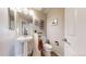 Bathroom with single sink and pedestal, toilet, and neutral decor, offering a clean and classic look at 6430 Silver Mesa Dr # D, Highlands Ranch, CO 80130