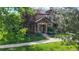 Inviting townhome exterior with lush greenery and brick accents at 6430 Silver Mesa Dr # D, Highlands Ranch, CO 80130