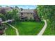 Lush front yard with mature trees and well-manicured lawn of a 2-story home at 6430 Silver Mesa Dr # D, Highlands Ranch, CO 80130
