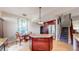 Open kitchen area with island, stainless appliances, and hardwood floors at 6430 Silver Mesa Dr # D, Highlands Ranch, CO 80130