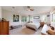 Comfortable bedroom with neutral decor, featuring a large window and ceiling fan at 6430 Silver Mesa Dr # D, Highlands Ranch, CO 80130