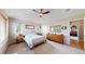 Tranquil bedroom featuring a comfortable bed, natural light and wood dresser at 6430 Silver Mesa Dr # D, Highlands Ranch, CO 80130