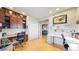 Well-lit office with built-in shelves and desk, offering hardwood floors and open access to living room at 6430 Silver Mesa Dr # D, Highlands Ranch, CO 80130