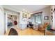 Stylish home office space with hardwood floors, bright white furniture, and views to the living room at 6430 Silver Mesa Dr # D, Highlands Ranch, CO 80130
