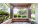 Charming covered patio with brick columns and mature landscaping at 6430 Silver Mesa Dr # D, Highlands Ranch, CO 80130