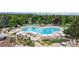 Upscale pool area with ample seating, landscaping, and mountain views in the distance at 6430 Silver Mesa Dr # D, Highlands Ranch, CO 80130