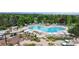 Expansive pool area with lounge chairs, umbrellas, and lush landscaping at 6430 Silver Mesa Dr # D, Highlands Ranch, CO 80130