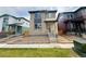 Charming two-story home featuring stone accents and a well-manicured lawn at 21152 E 63Rd Dr, Aurora, CO 80019