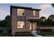 Modern two-story home featuring mixed siding, prominent windows, and a welcoming front porch at 21152 E 63Rd Dr, Aurora, CO 80019
