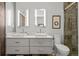 Contemporary bathroom with double vanity, modern mirrors, and tiled shower at 1050 Cherokee St # 403, Denver, CO 80204