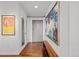 Hallway with hardwood floors and modern decor, including a large art piece at 1050 Cherokee St # 403, Denver, CO 80204
