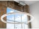 Modern circular light fixture against large windows and exposed concrete wall at 1050 Cherokee St # 403, Denver, CO 80204