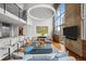 Spacious living room featuring concrete wall, modern decor, and floor-to-ceiling windows with city views at 1050 Cherokee St # 403, Denver, CO 80204