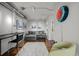 Cozy sitting area features a desk, comfortable sofa, and unique neon wall clock at 1050 Cherokee St # 403, Denver, CO 80204