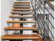 Floating staircase with wooden treads and industrial-style metal railings at 1050 Cherokee St # 403, Denver, CO 80204