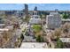 An aerial view of a neighborhood in the city showcases houses, apartment buildings and mature trees at 1349 Race St # 5, Denver, CO 80206
