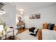 Bright and cozy living room features stylish sofa, cow-hide ottoman, art and decor at 1349 Race St # 5, Denver, CO 80206