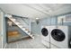 Finished basement laundry area with washer, dryer, and storage at 1127 Clayton St, Denver, CO 80206