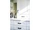 White bathroom vanity with black hardware and quartz countertop at 1127 Clayton St, Denver, CO 80206