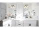 Double vanity bathroom with white cabinets, quartz countertops, and black fixtures at 1127 Clayton St, Denver, CO 80206