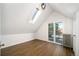 Bedroom with vaulted ceiling, hardwood floors, and private balcony access at 1127 Clayton St, Denver, CO 80206