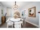 Modern dining room with a round table and white chairs at 1127 Clayton St, Denver, CO 80206