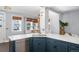 Modern kitchen with blue cabinetry, quartz countertops, and stainless steel appliances at 1127 Clayton St, Denver, CO 80206