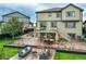 Spacious backyard featuring a deck, patio, dining area and fire pit with lounge seating at 16747 E 97Th Pl, Commerce City, CO 80022