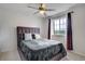 Bedroom showcasing a tufted headboard, a ceiling fan, and a window with blackout curtains for optimal light control at 16747 E 97Th Pl, Commerce City, CO 80022