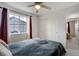 Bedroom with a ceiling fan, window with black-out curtains, and closet at 16747 E 97Th Pl, Commerce City, CO 80022