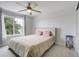 Cozy bedroom featuring a ceiling fan, a patterned carpet, and a window that provides plenty of natural light at 16747 E 97Th Pl, Commerce City, CO 80022