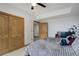 Cozy bedroom features a soft bed with plush pillows, complemented by classic wood doors at 16747 E 97Th Pl, Commerce City, CO 80022
