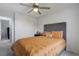 A well-lit bedroom with a ceiling fan, closet, and soft, neutral colors at 16747 E 97Th Pl, Commerce City, CO 80022