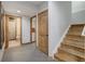 Hallway with tile floor and access to a bathroom, laundry room, and stairs at 16747 E 97Th Pl, Commerce City, CO 80022