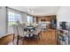 Spacious dining area leading to an island kitchen, with dark cabinetry and stainless appliances at 16747 E 97Th Pl, Commerce City, CO 80022