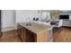 Kitchen island with granite countertops and stainless steel appliances at 16747 E 97Th Pl, Commerce City, CO 80022