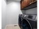 Convenient laundry room featuring modern front-load washer and dryer for efficient cleaning at 16747 E 97Th Pl, Commerce City, CO 80022