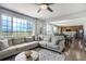 Open-concept living room with large windows and seamless flow into the dining and kitchen area at 16747 E 97Th Pl, Commerce City, CO 80022